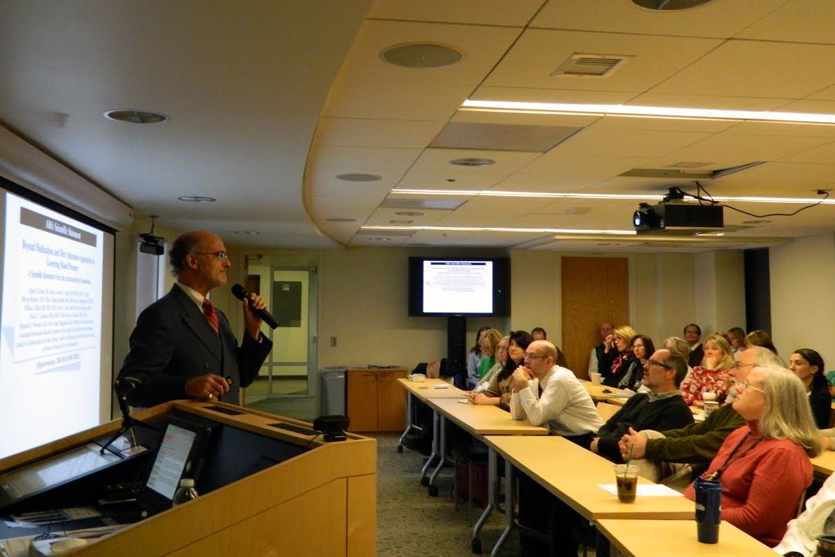 Dr. Robert Schneider speaks at the University of Iowa Medical School