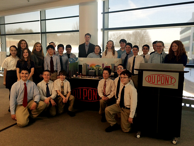 Delaware DNREC Secretary Collin O'Mara and students from the Holy Angels School in Newark, DE with the model the students built for an engineering competition.