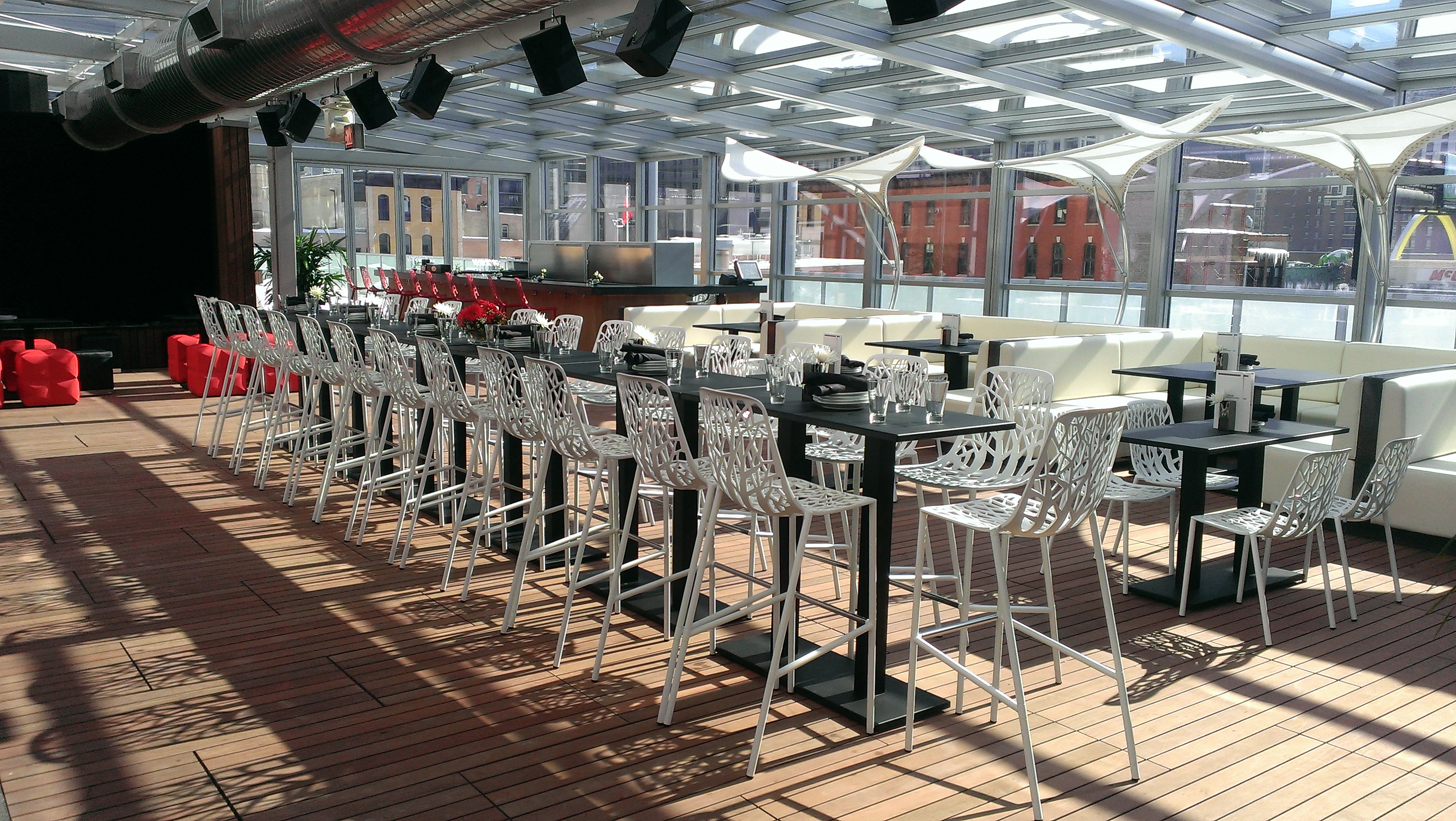 Lounge area of Godfrey Hotel's IO Urban Roofscape under Libart enclosure.