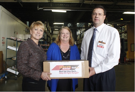 Suzanne Meeks of Hunger Buster, Eileen Bradshaw of the Community Food Bank of Eastern Oklahoma and Mike Naylor of Reasor's pose with a portion of donated beef sticks at the Community Food Bank.