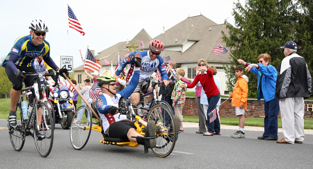 Riders participating in World T.E.A.M. Sports events are often welcomed by local residents, such as this group near Gettysburg during the 2013 Face of America ride. Photograph by Kimberly Warpinski.