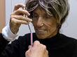 Patient at Regents Park Boca Raton tests her ability to place a stick within a straw.