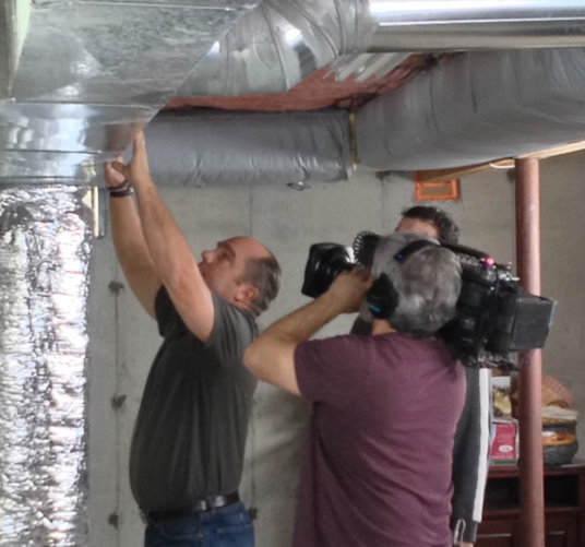 HVAC expert Richard Tretheway examines duct leaks sealed with aeroseal during taping of Ask This Old House