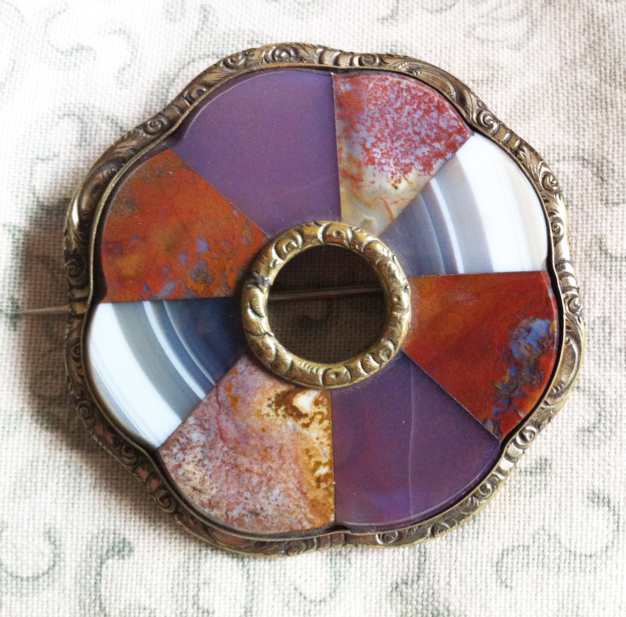 Circular brooch with mosaic of polished Scottish hardstones