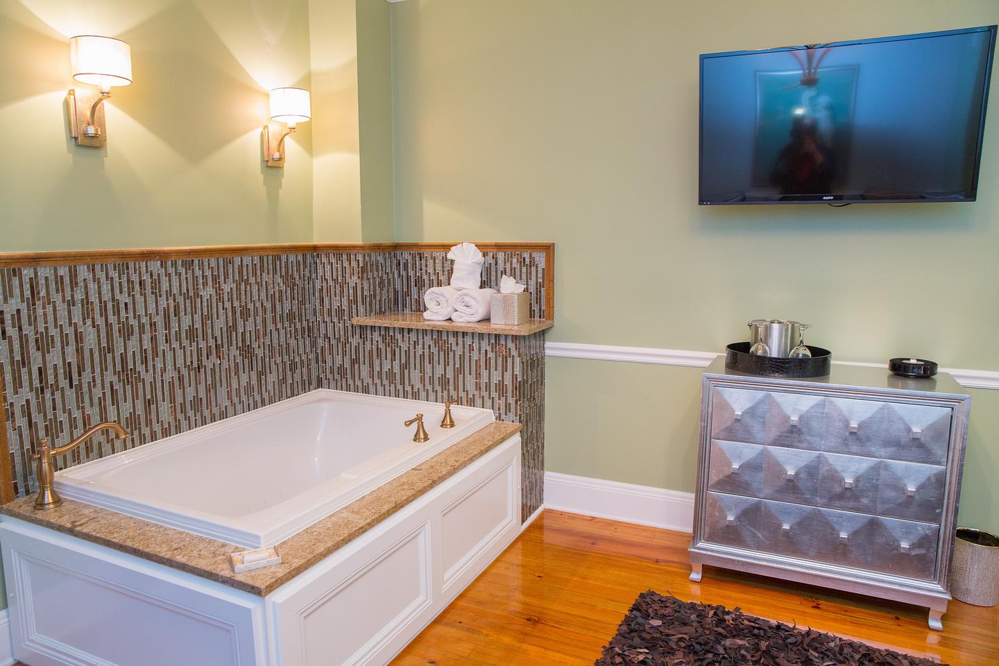 Travelers to St. Augustine can relax after a long day in this luxurious jetted tub. The sconces are on dimmers for a romantic atmosphere.