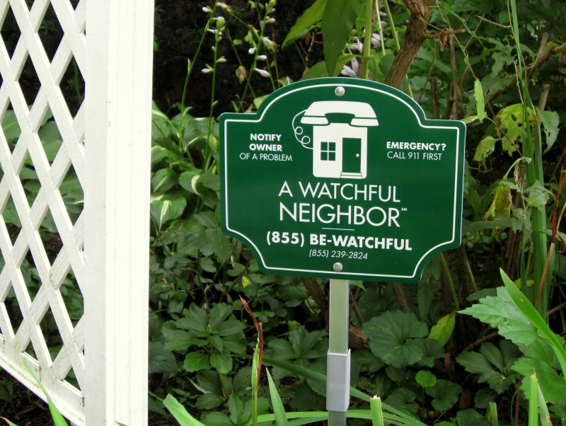 A Watchful Neighbor yard sign