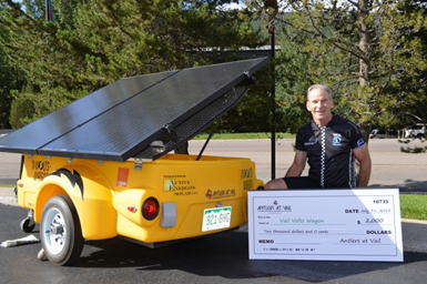 Antlers at Vail General Manager Rob LeVine next to the Town of Vail solar-powered VoltsWagon that the Antlers helped sponsor.