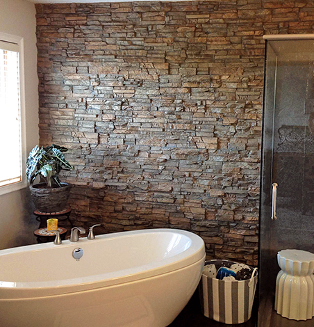 Faux stone panels create the perfect spa-like retreat.