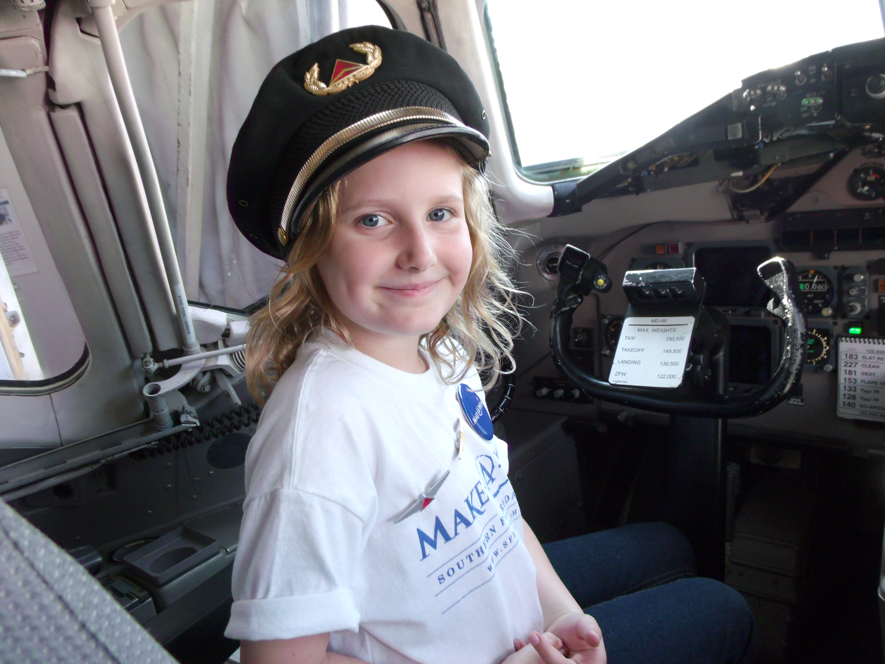 Simone, a 10-year-old wish kid from Southern Florida who has a life-threatening nervous disorder, poses for a quick photo in the cockpit before her flight to New York City.