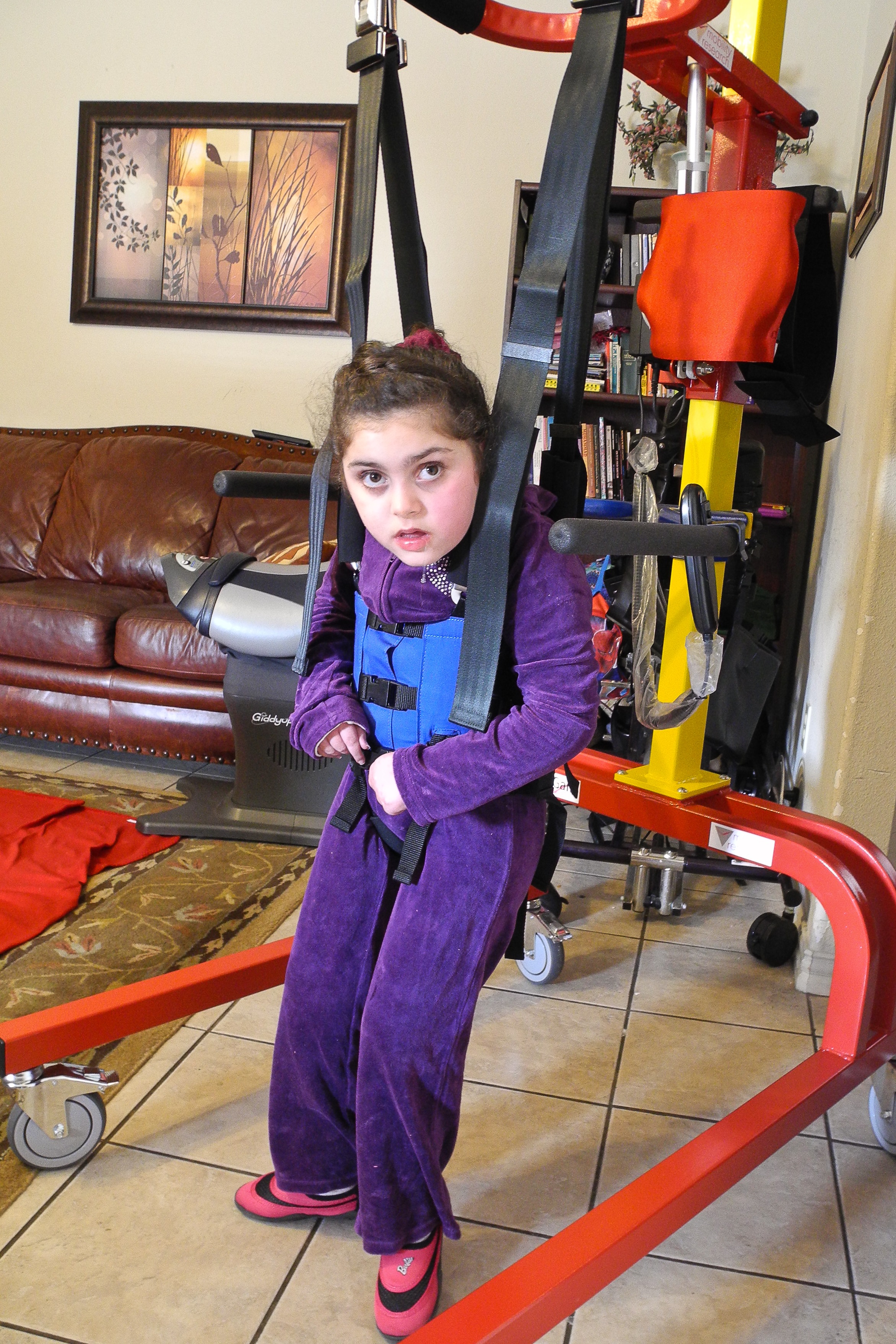 A nine-year-old girl in Garland, Texas, uses her LifeGait therapy device provided with support from HOPE4JD.