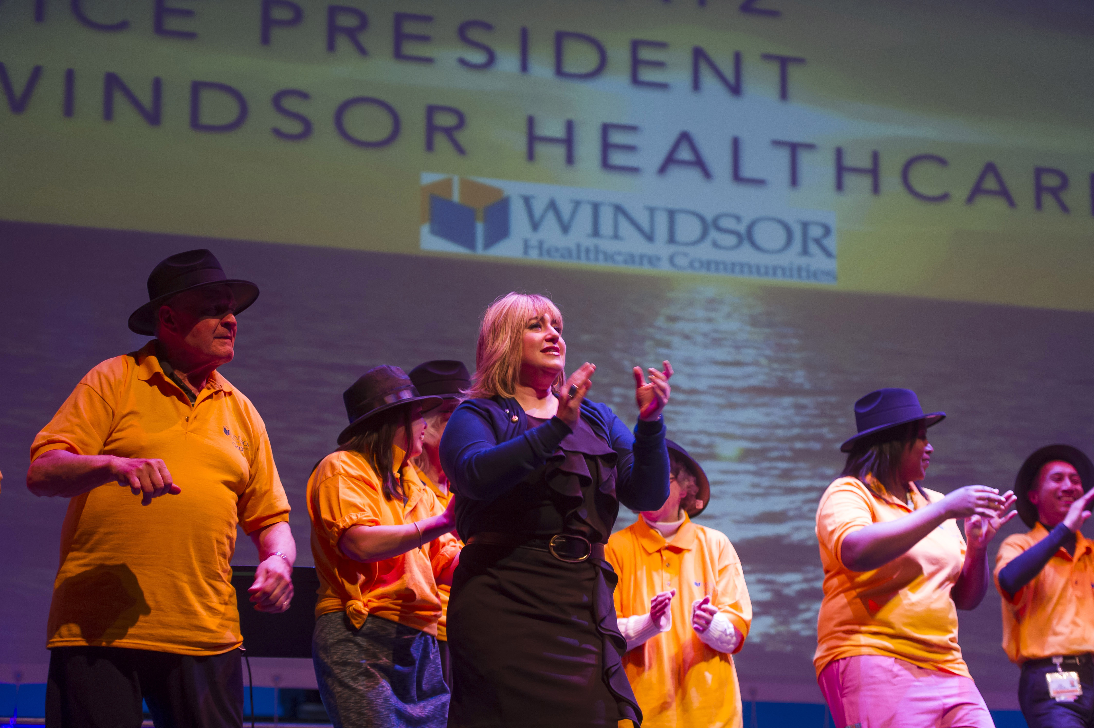 Batsheva Katz, VP of Windsor Healthcare, and the Windsor Healthcare choir of elders from nine New Jersey nursing homes sing “Happy” and dance at NJ Performing Arts Center.  (Matt Rainey)