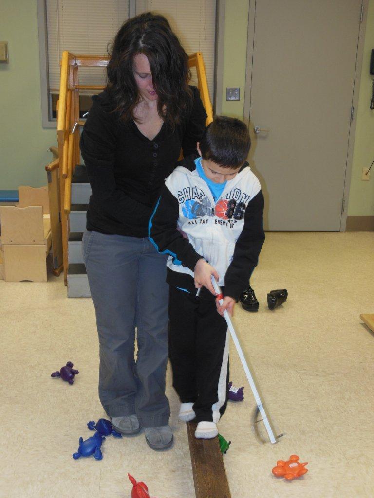 Michael Pidgeon, age 2, works with his Easter Seals NH Autism Support Provider Kathleen Swirderski on the iPad. The tablets are used often in therapy for non-verbal clients as a means of helping them