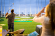 A golfer takes a swing at Topgolf in Spring, TX.