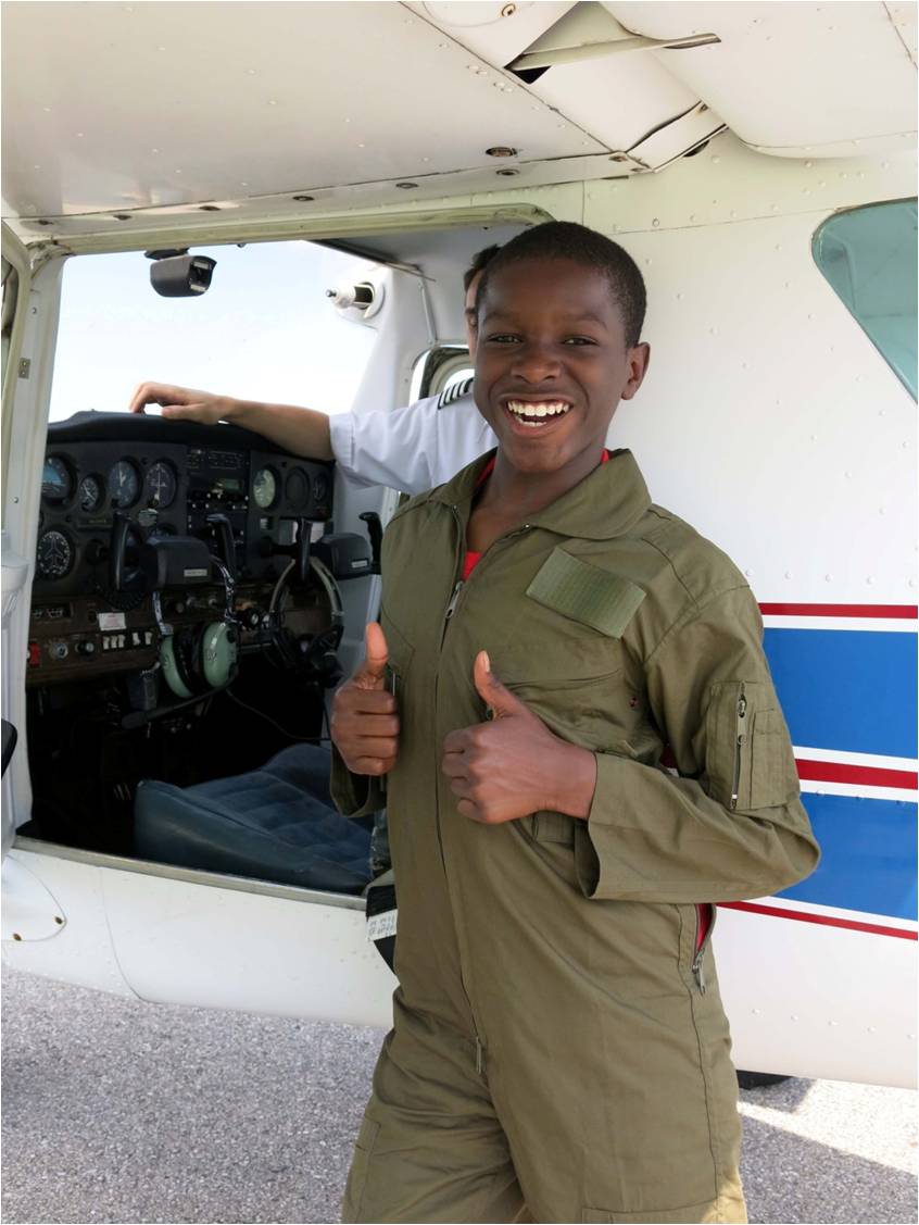 Air Camp student gives two thumbs-up for his first flight.