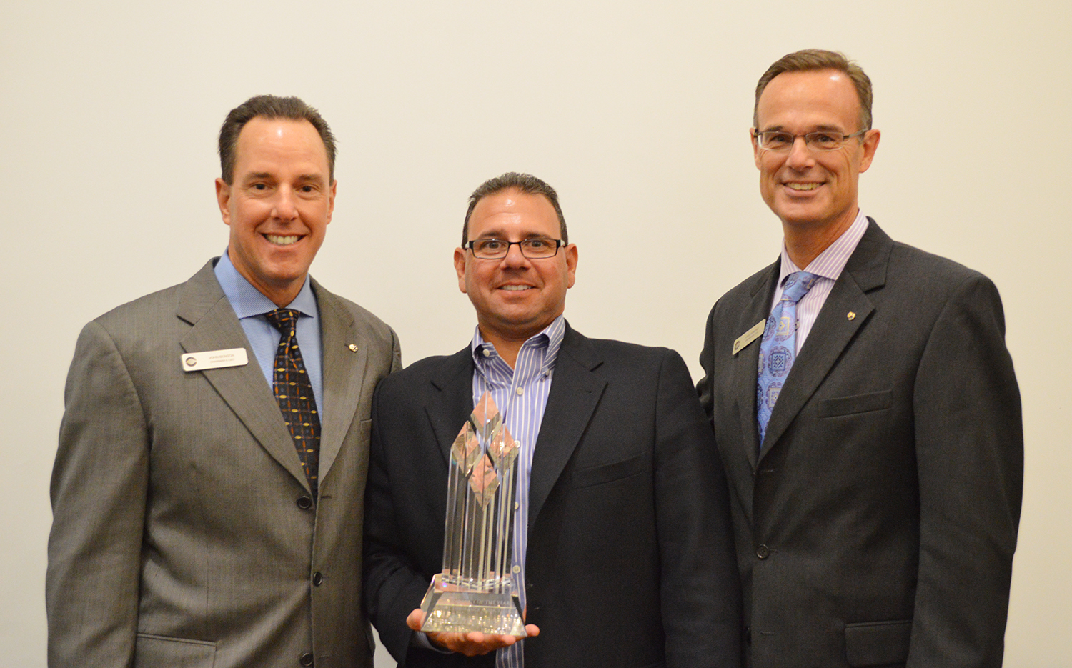 Frankenmuth Insurance Chairman & CEO John S. Benson (left) and President and COO Fred Edmond (right) present the company's 2013 Agency of the Year award to HBL Insurance Principal Mark Hatz.
