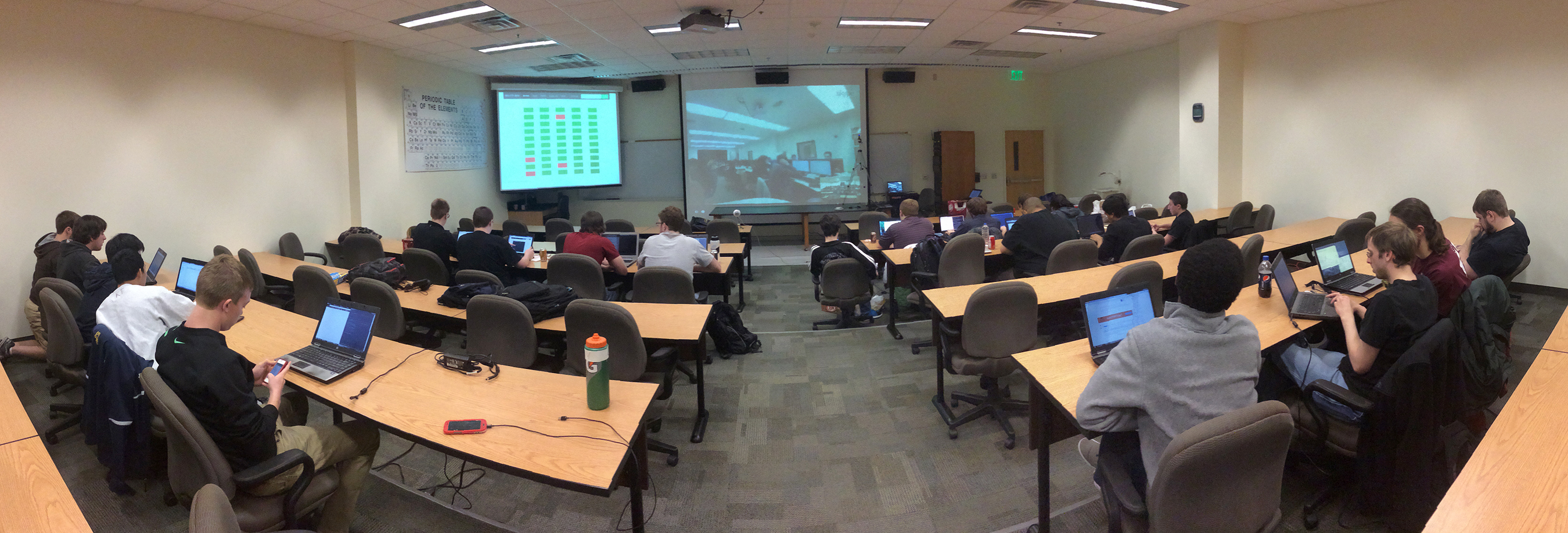Panoramic view of the hacking competition at Buena Vista University and the screen displaying the web camera feed from Whitworth University
