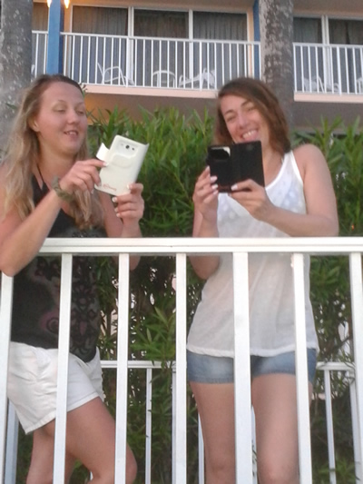 Katie and Jen on the beach using RF Safe flips cases for safer cell phones