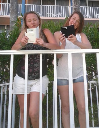 Katie and Jen using RF Safe cell phone radiation shielded flip cases while on holiday in North Redington Beach