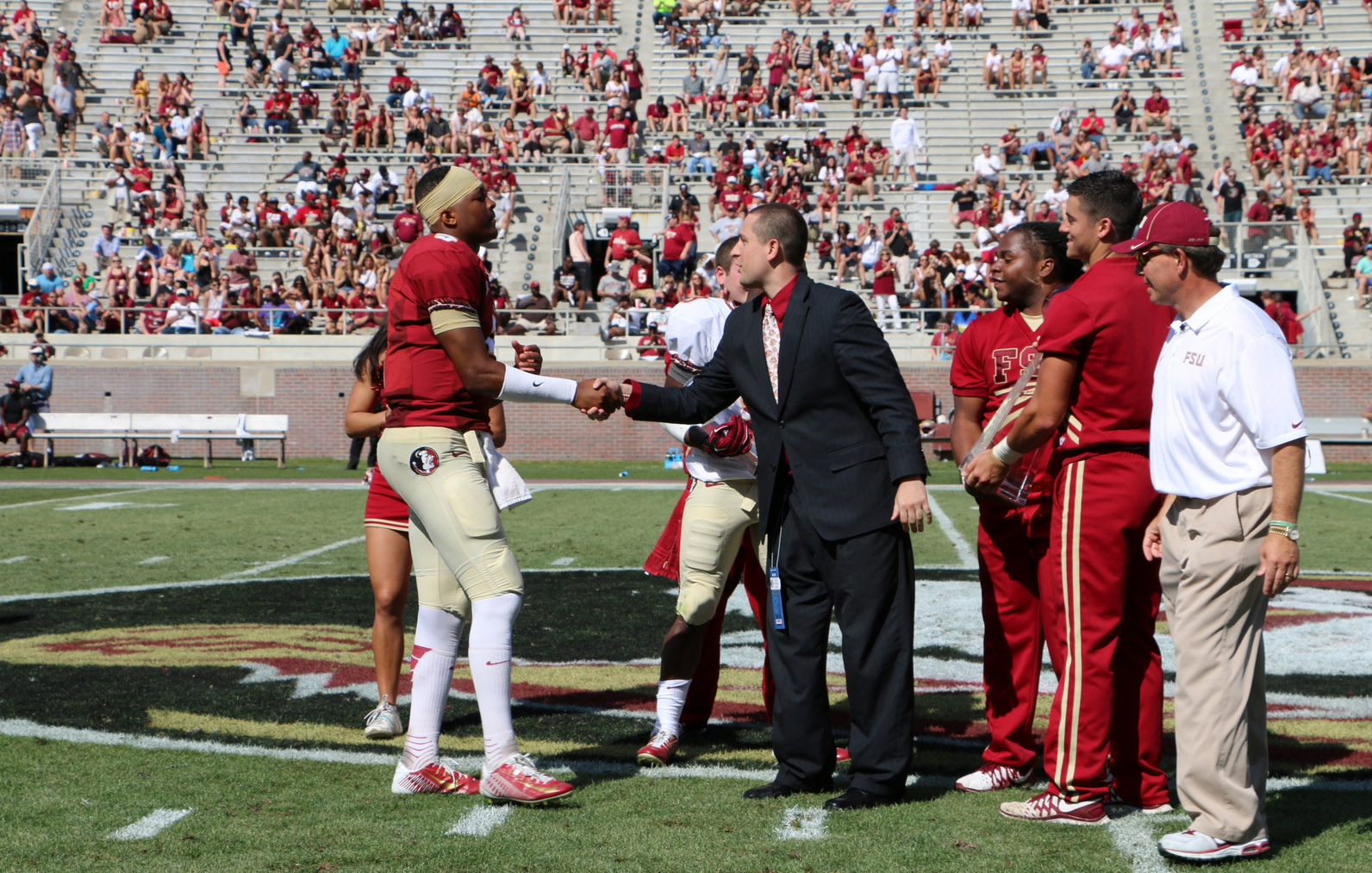 CFPA Executive Director Brad Smith congratulates Jameis Winston
