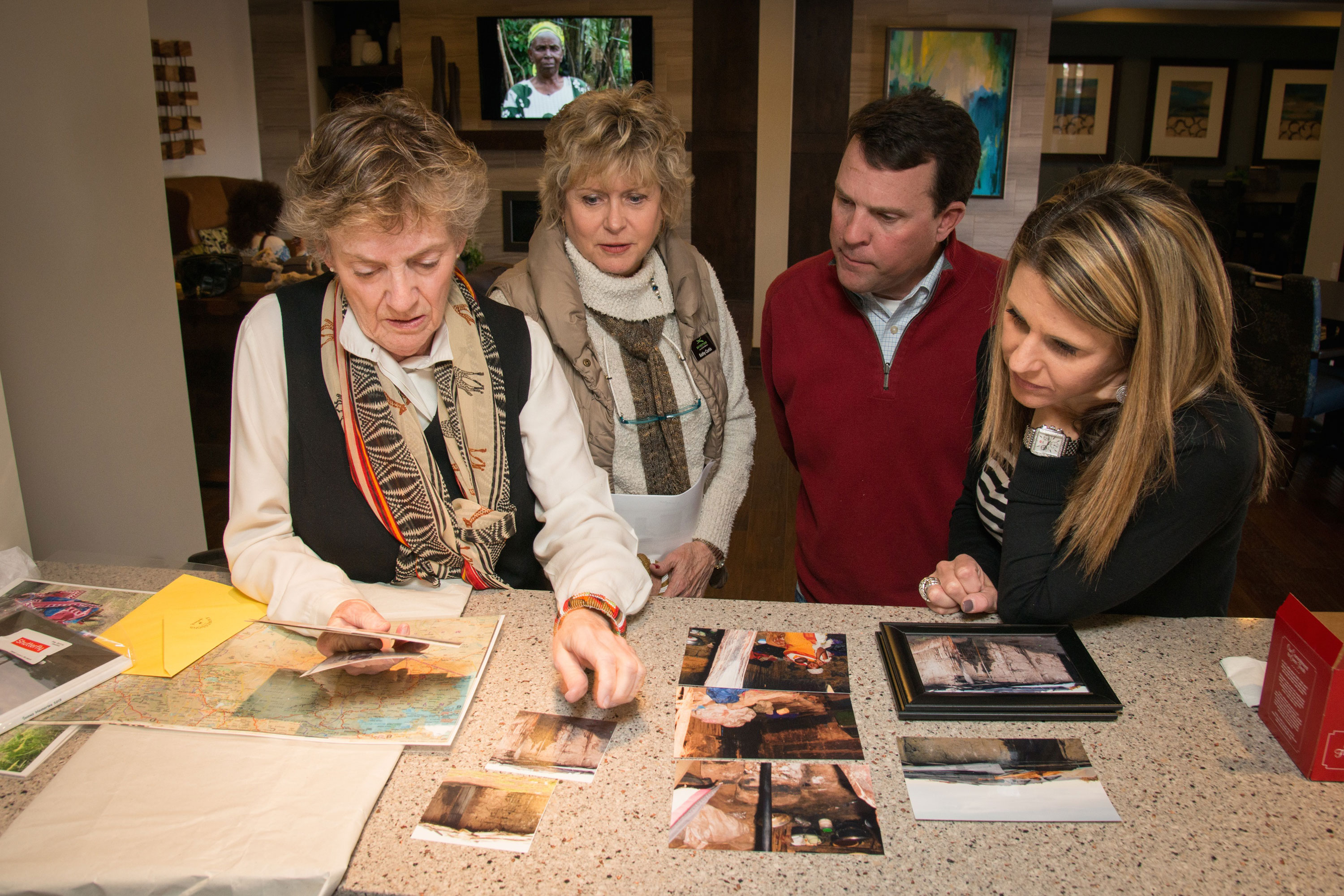 Judy Pitt shows the Taylor Morrison Denver team photos from her humanitarian travels to Kenya.