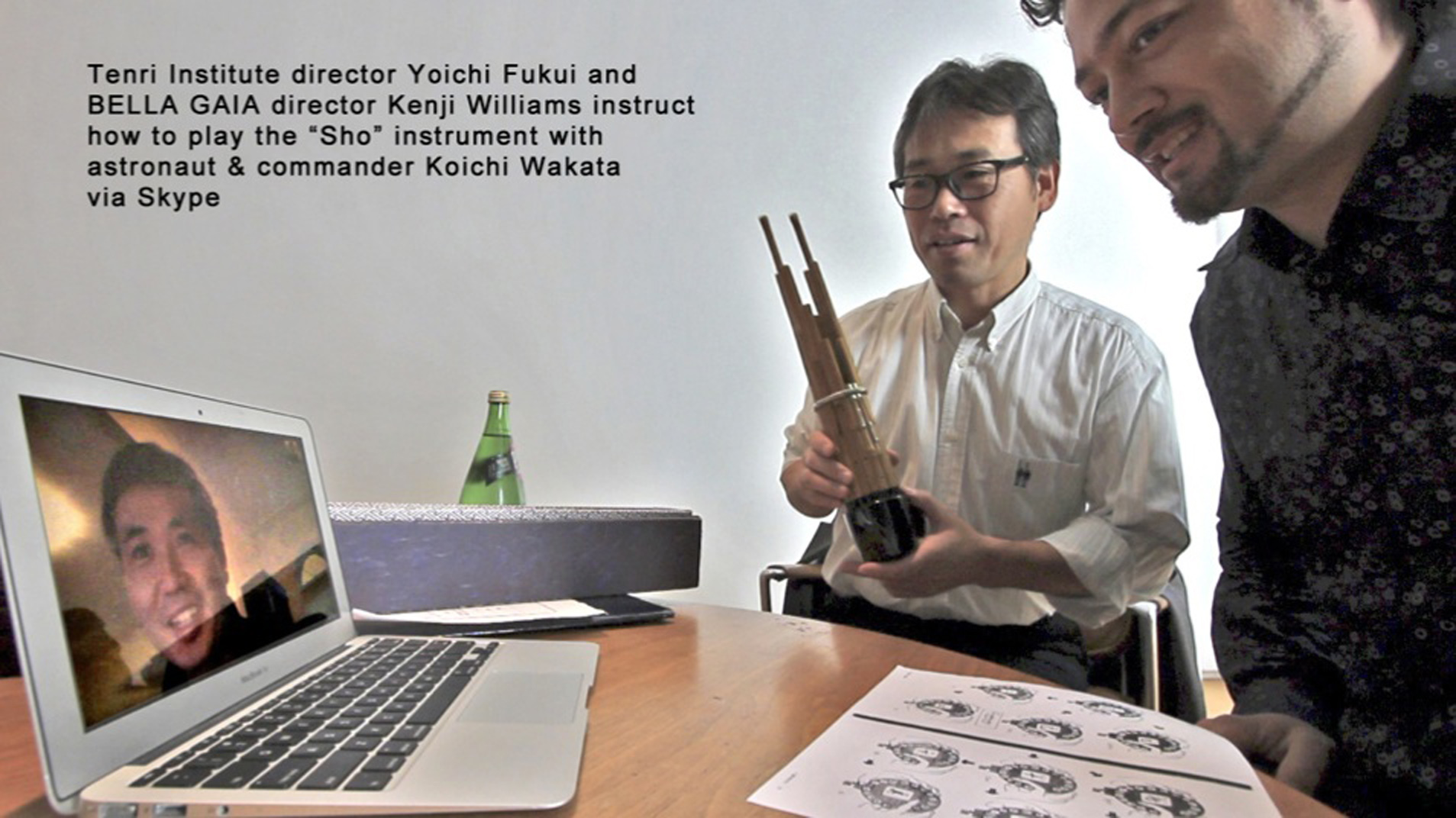 Tenri Institue director Yoichi Fukui and BELLA GAIA director, Kenji Williams instruct how to play the "Sho" instrument with astronaut and commander Koichi Wakata via Skype.