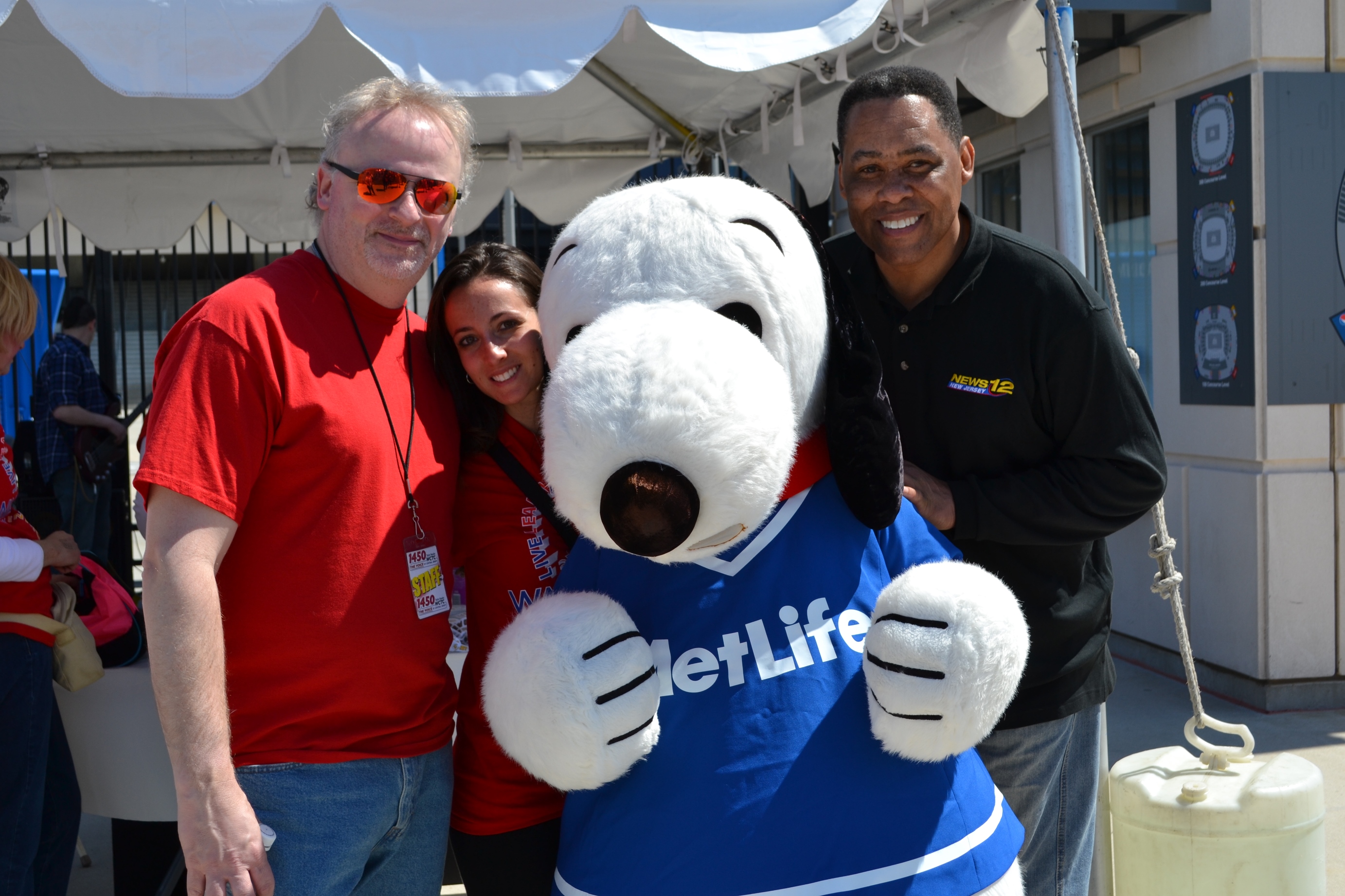 Radio Host Bert Baron from 1450 WCTC AM and News12 Anchor Bryan Jenkins pose with Snoopy at Easter Seals NJ's 5th Annual Walk With Me and 5K Run at MetLife Stadium