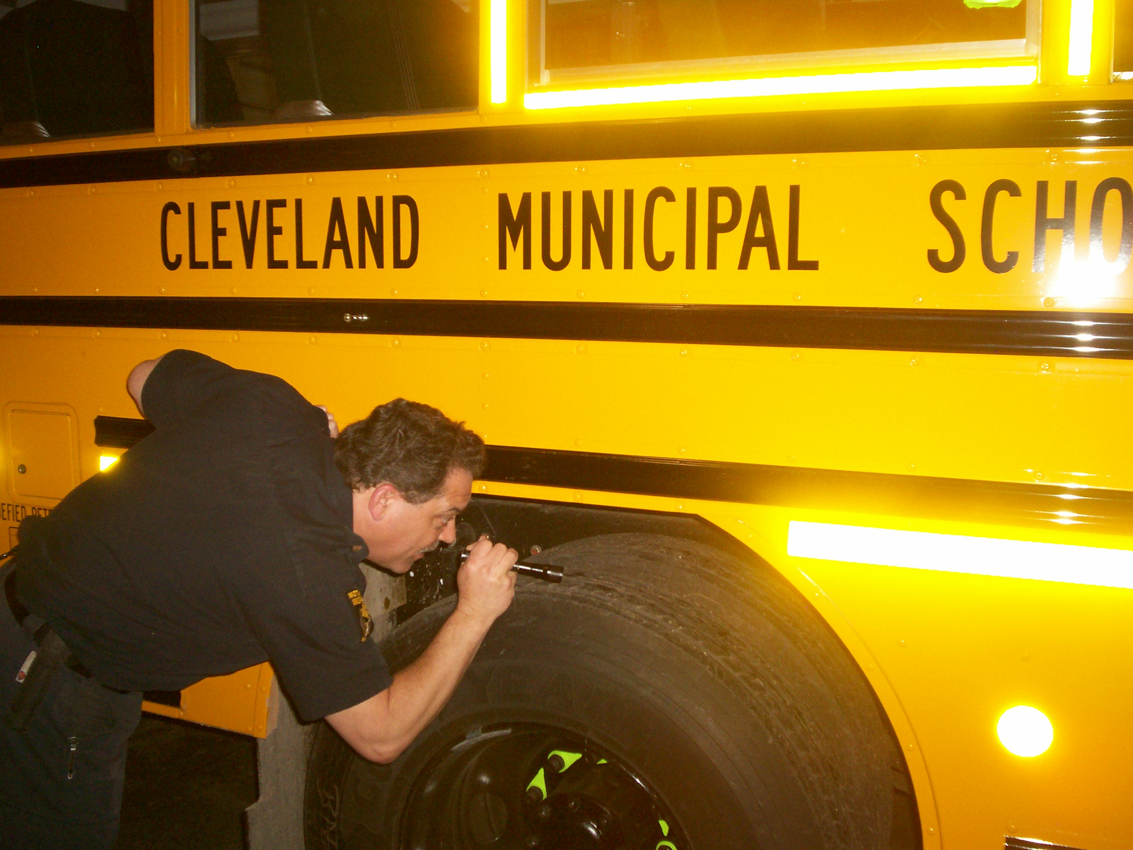 Ohio state inspector John Rose examines one of Cleveland School's new school buses fueled by clean and economical propane autogas.