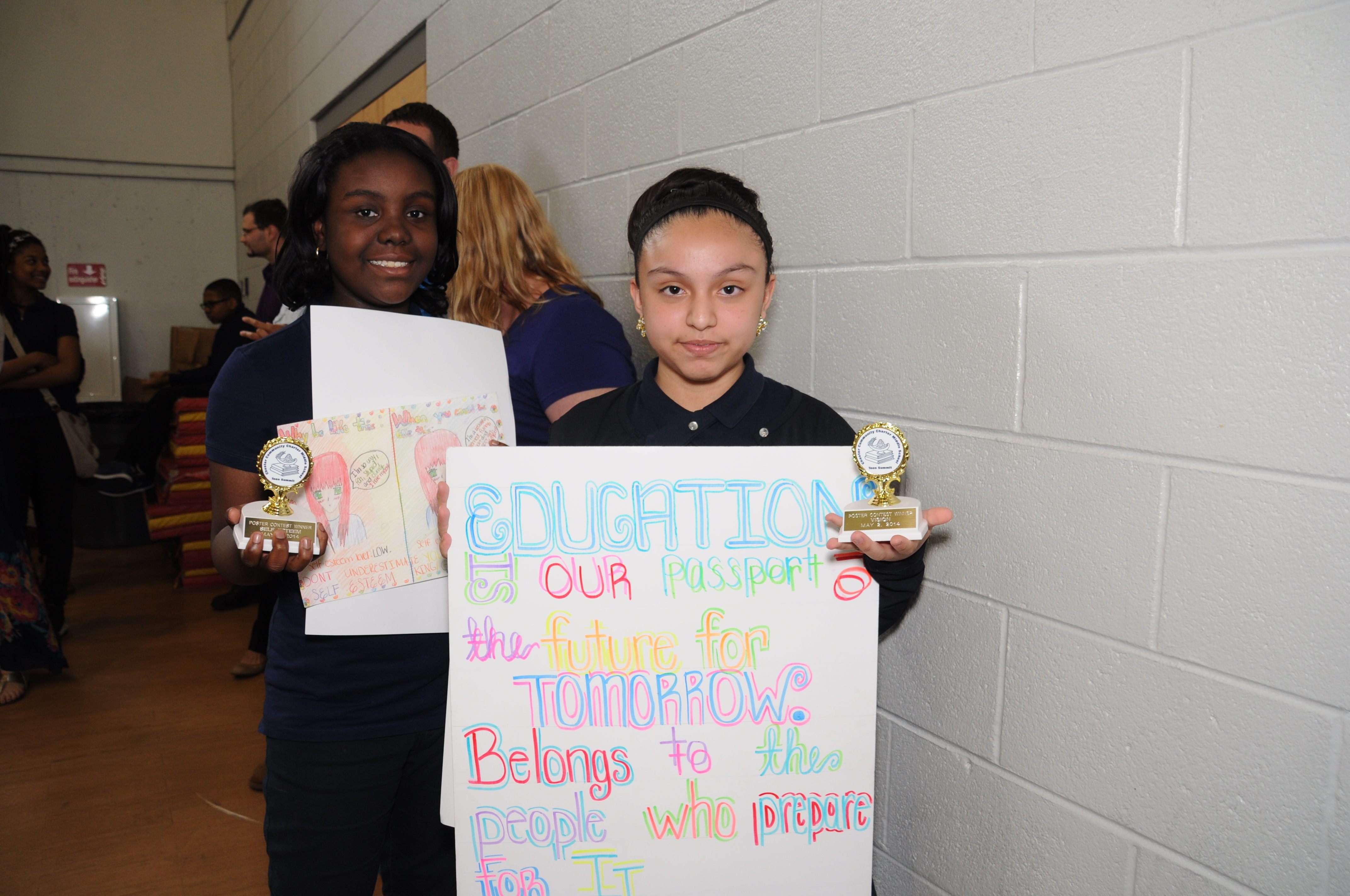 Chester Community Charter School seventh-graders, Tiana Watkins (left) and Megan Magallanes (right), were two of six recipients, who were awarded trophies for their “social issues” posters at the scho