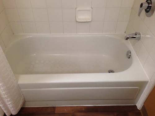 Before - this hotel bathtub and tile surround was run down and extremely difficult to clean