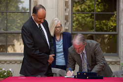 Claremont Graduate University Executive Vice President and Provost Jacob Adams (right), CGU President Deborah Freund (center), and Dr. Mohamed Helmy El Borai, director of the Egyptian Cultural and Educational Bureau (left), sign an agreement to encourage