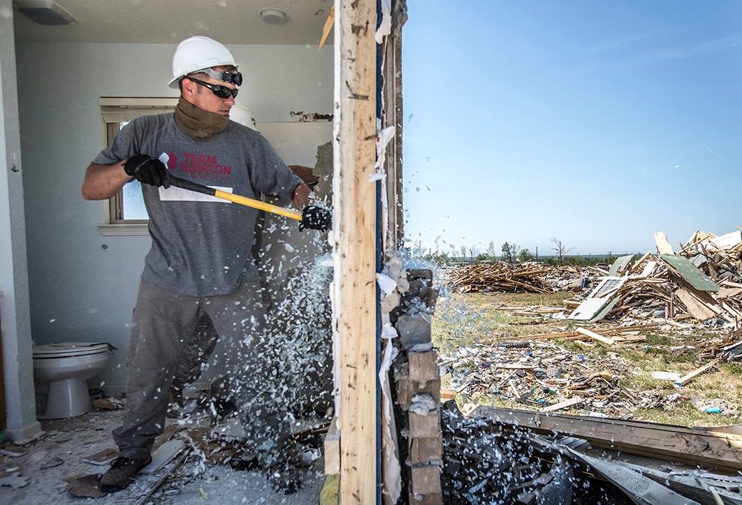 Cody Wright, Army National Guard, helps Team Rubicon demo a home in Vilonia, Ark. Photo by Kirk Jackson.