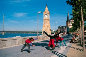 Cartwheeling kids on in Düsseldorf's Rhine River Promenade