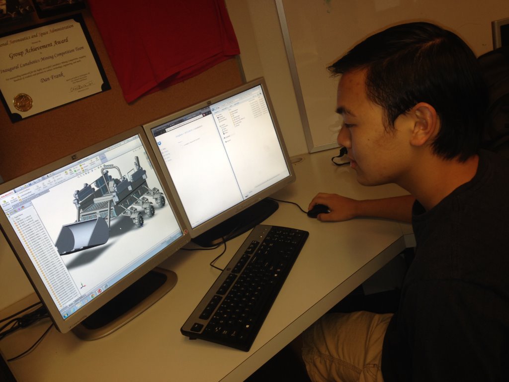 Rocklin High School student Paulo Buencamino reviews a lunabotics design.