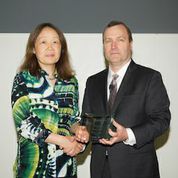 Dr. Jie Shen receives Promising Research Award in Alzheimer’s Disease from MetLife Foundation President A. Dennis White.  Credit:  Marc Baroni