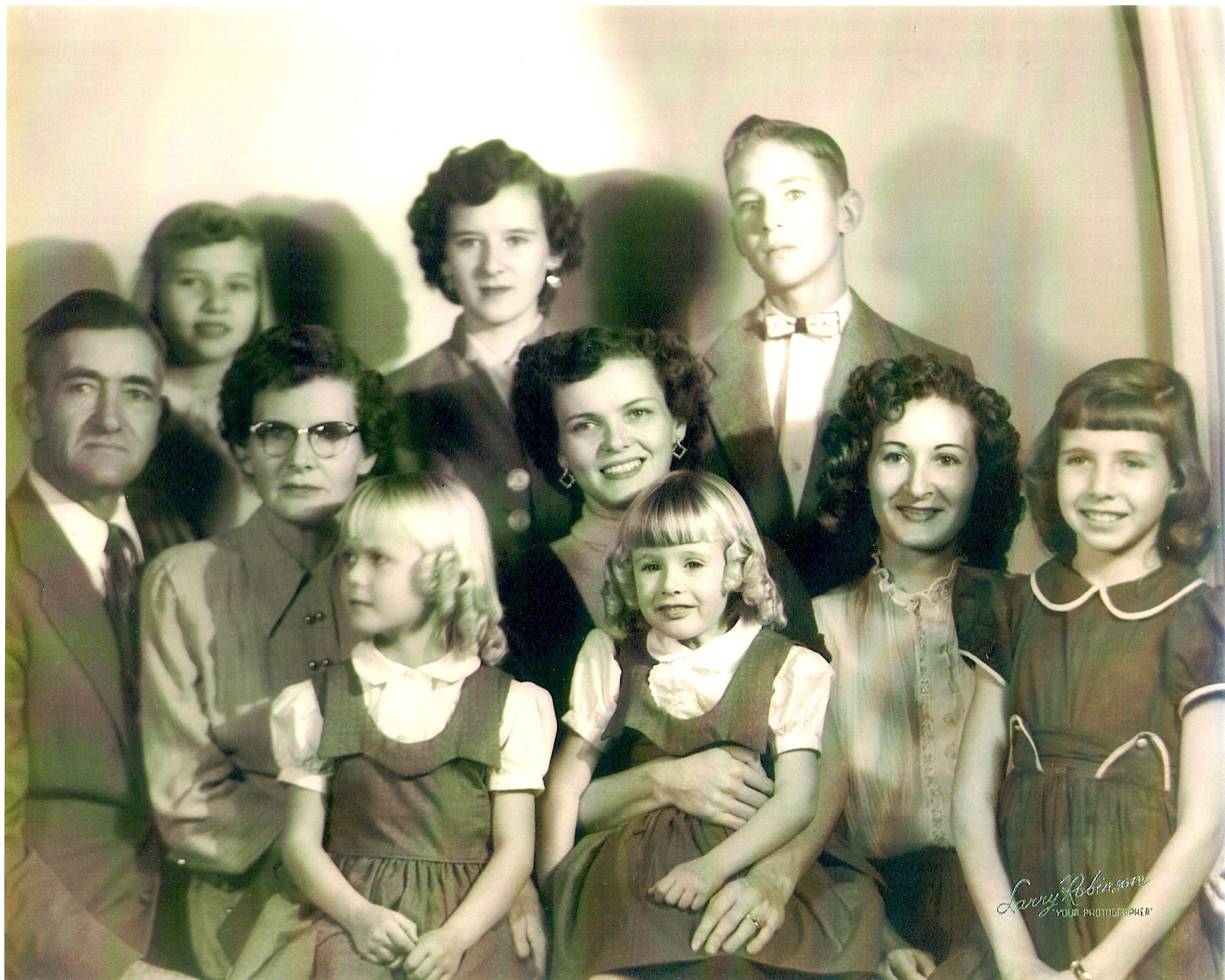 Portrait of author Nancy Powell (center) with her parents and her seven childen. Handed-down family stories inspired Powell to spend a number of years honing her craft as a writer.