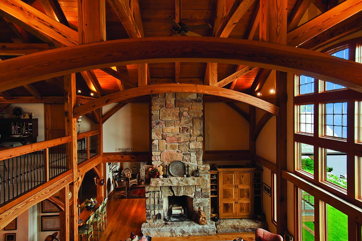 This timber frame home by New Energy Works highlights the uses of reclaimed antique Heart Pine timbers.