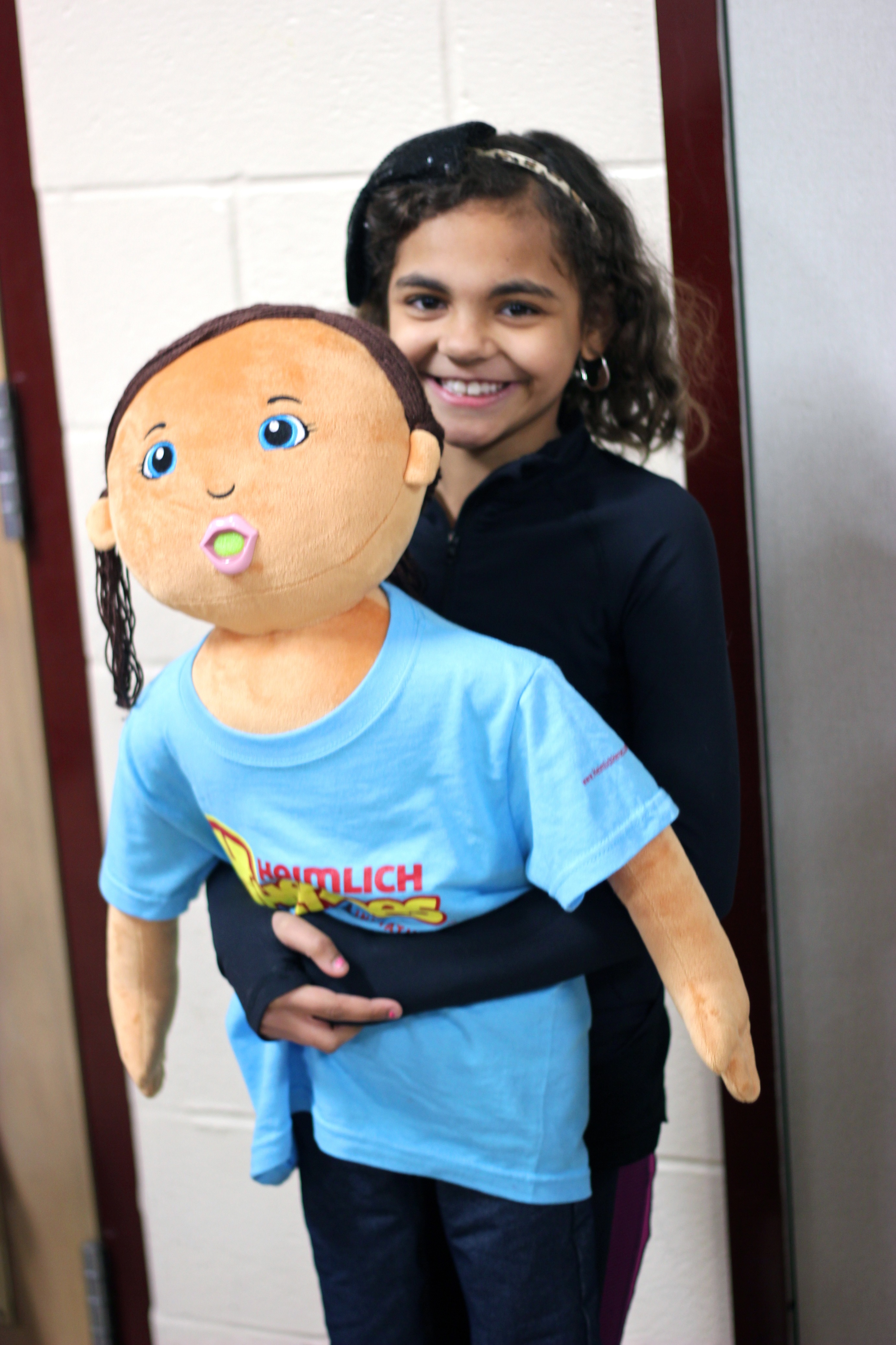 A participant practices the Heimlich Maneuver during a Heimlich Heroes program. (L.E. Witcher Photography)