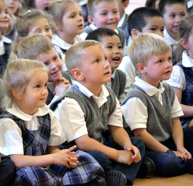 Everest Academy prek students concentrated on the puppet show