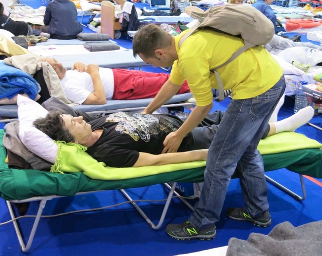 In a Belgrade shelter, Volunteer Minister provides a Scientology assists, a technique developed by Scientology Founder L. Ron Hubbard that helps the individual overcome stress and trauma.