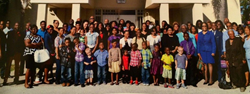 Members of the Faith Deliverance Temple Community pictured in front of the beloved church building.