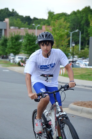 A child cycles toward victory during the Morrison Family YMCA’s Kids Tri Ballantyne.