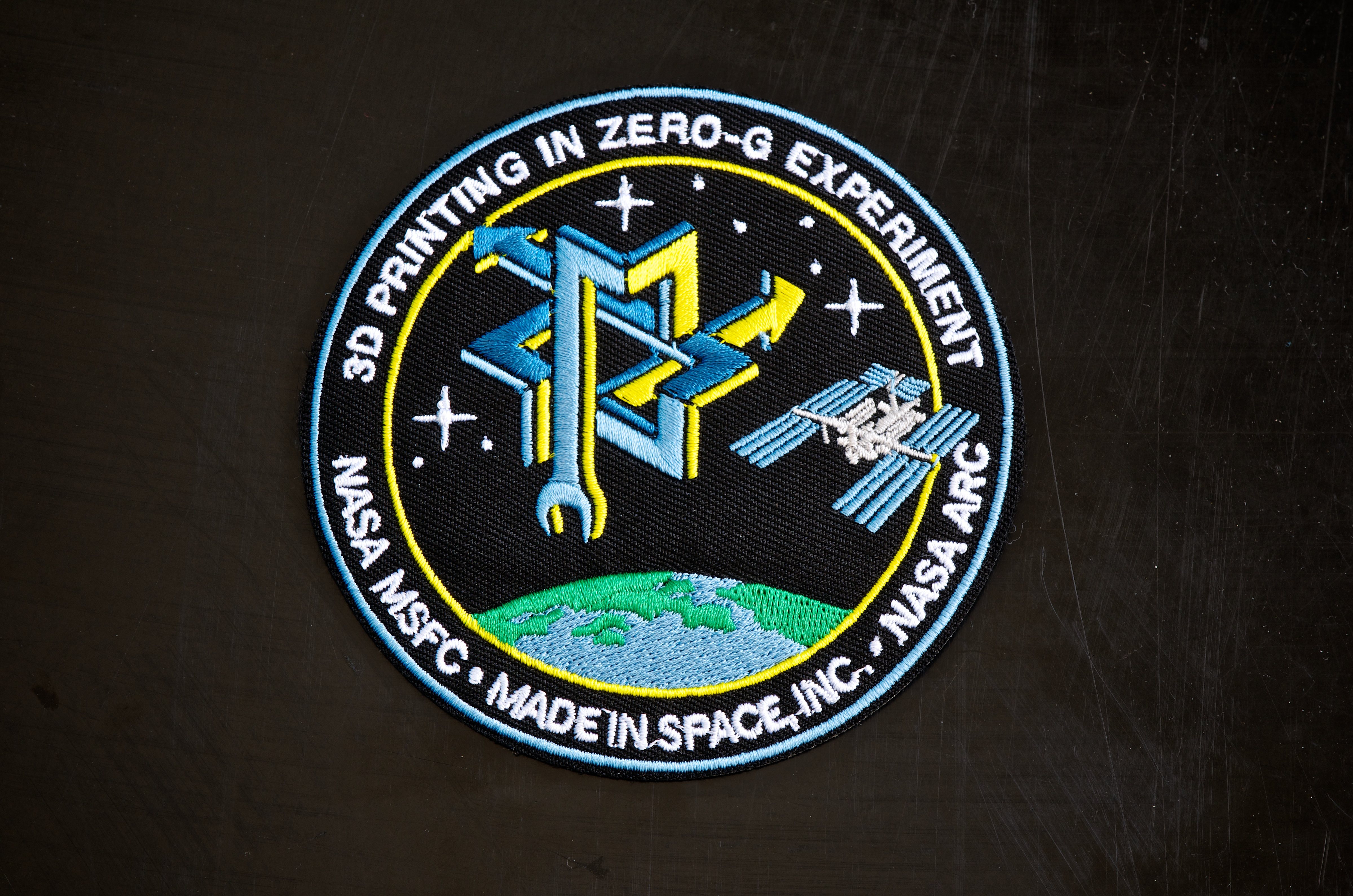The 3D Printing in Zero-G Experiment mission patch symbolizes the partnership between Made In Space and NASA in bringing Additive Manufacturing to space.