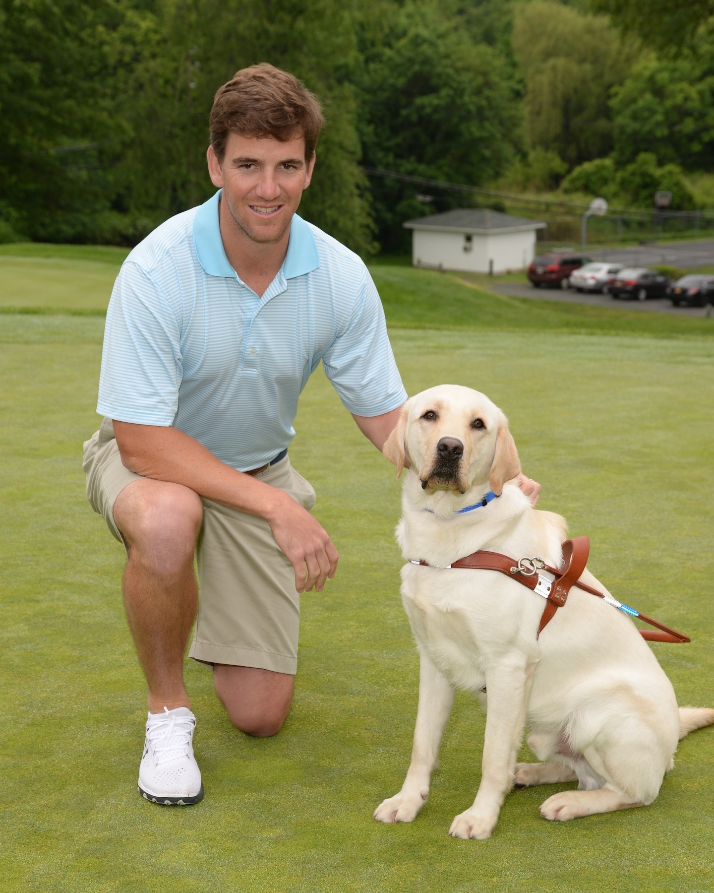 NY Giants Quarterback and eight-time Guiding Eyes for the Blind Golf Classic host Eli Manning with Guiding Eyes Jansen at the 37th annual Guiding Eyes for the Blind Golf Classic.