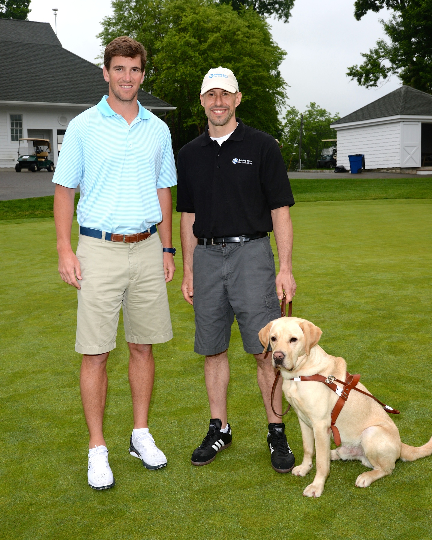 NY Giants Quarterback Eli Manning and Guiding Eyes’ president & CEO Thomas Panek (of South Salem) with Guiding Eyes Gus at the 37th annual Guiding Eyes for the Blind Golf Classic.