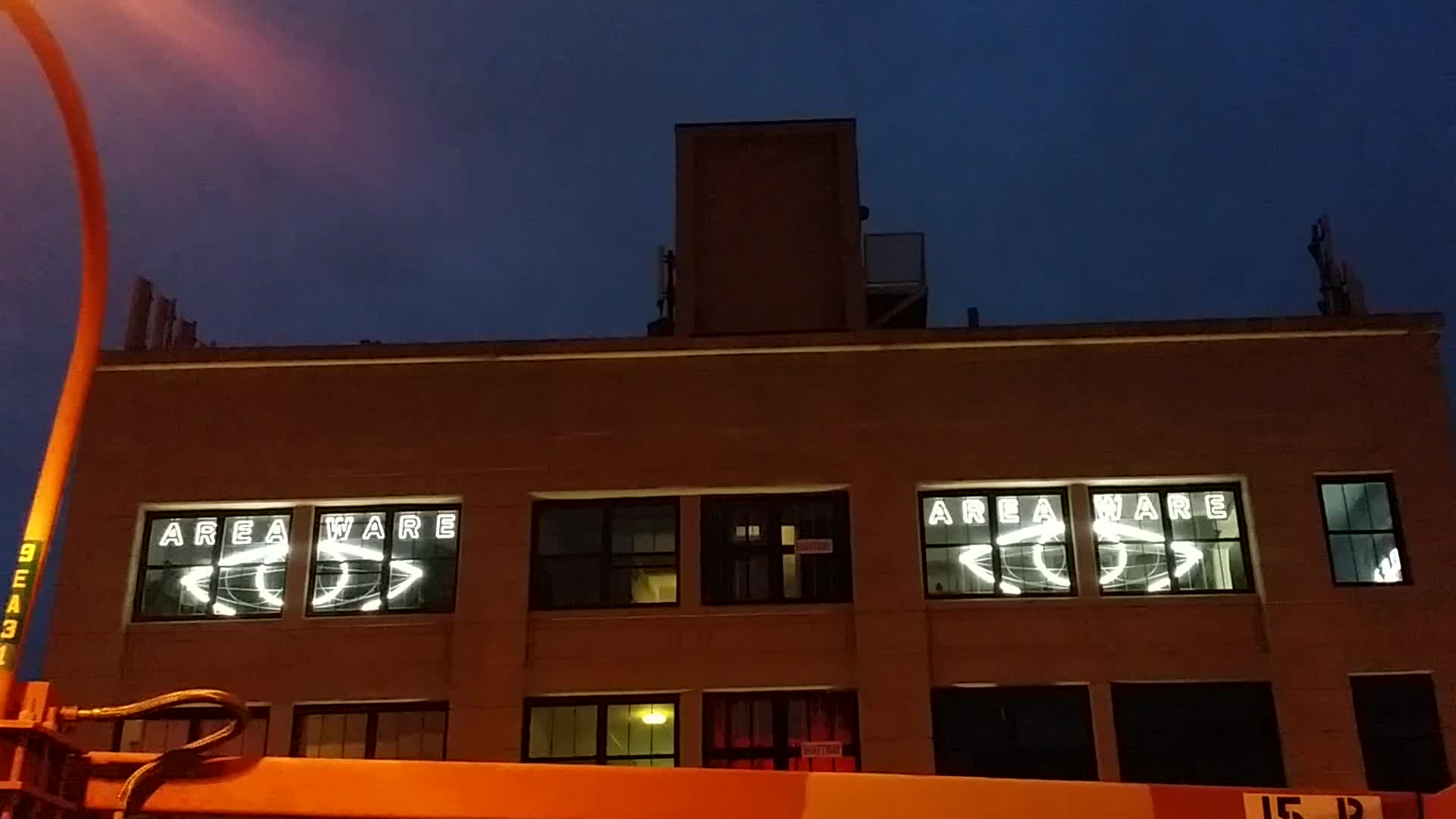 Areaware's neon eyes as seen from street level in Williamsburg, NY