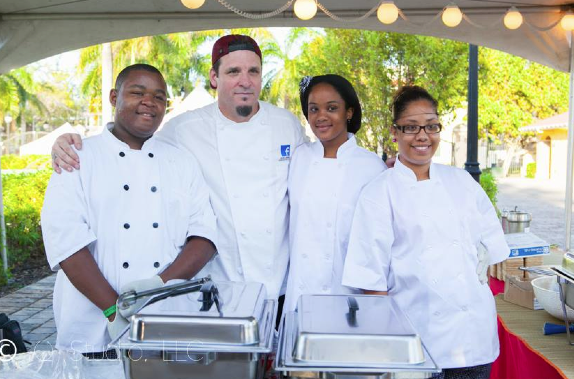 Chef Dean Spinks of Facebook works with local high school students to prepare for the Sunset BBQ. Photo by Quiana Duncan.