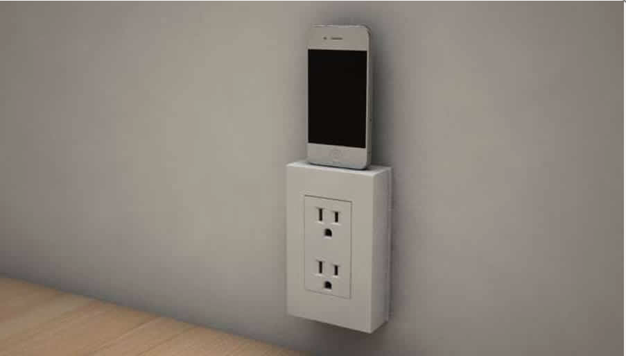 Shows a smart phone charging while utilizing the device.