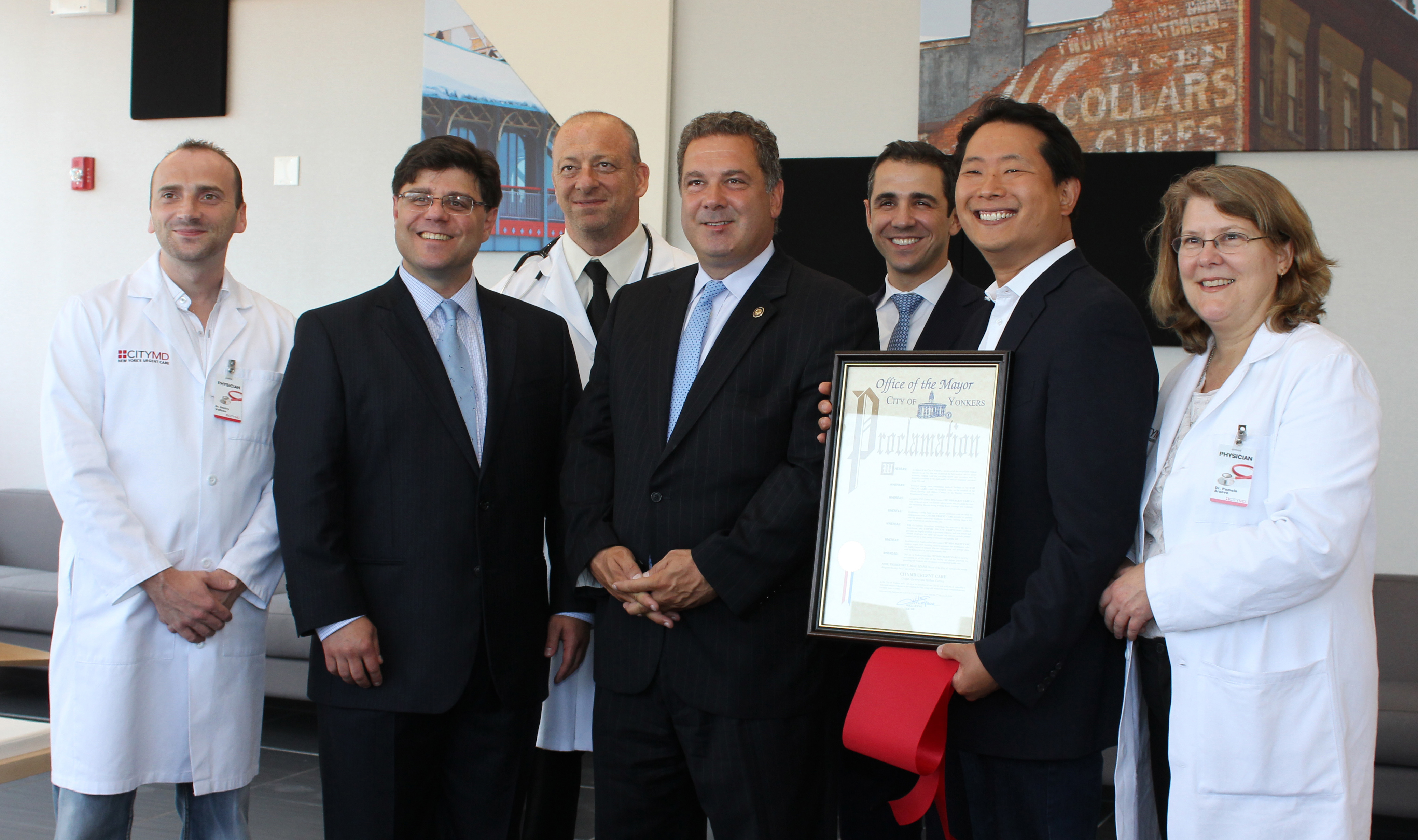 Photo Caption 1 (L to R): Pictured displaying the Proclamation from the City of Yonkers is (Front Row) CityMD Yonkers Medical Director Dr. Frank Illuzzi, City of Yonkers Mayor Mike Spano and CityMD Ch