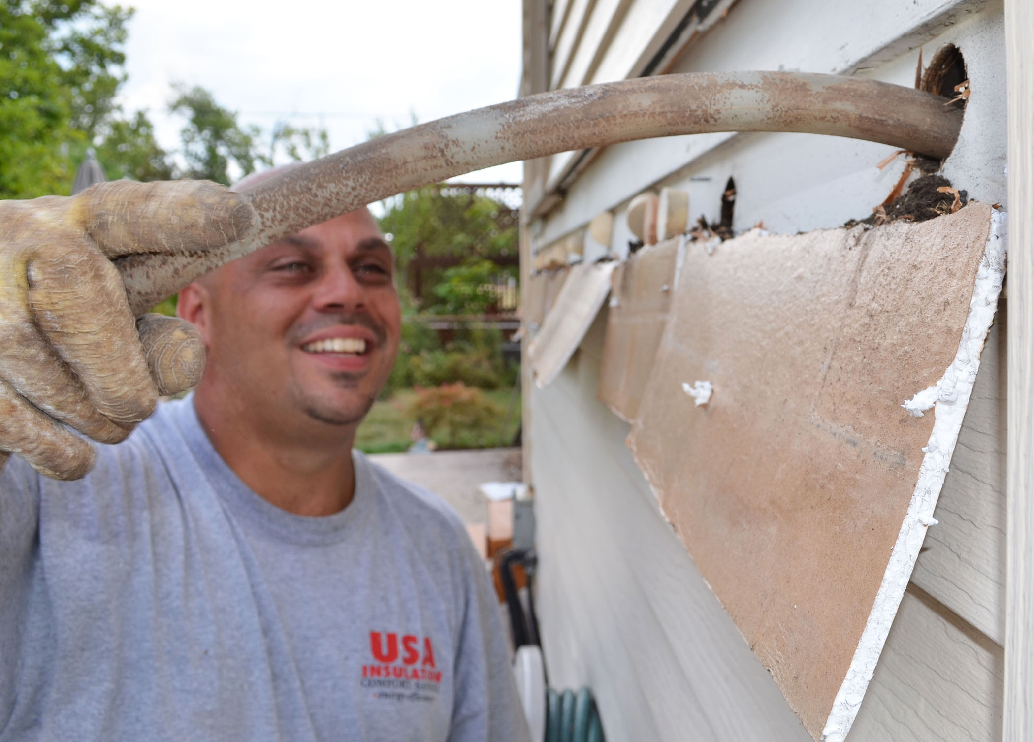 Installer injects USA Premium Foam into the wall cavity from outside the home.