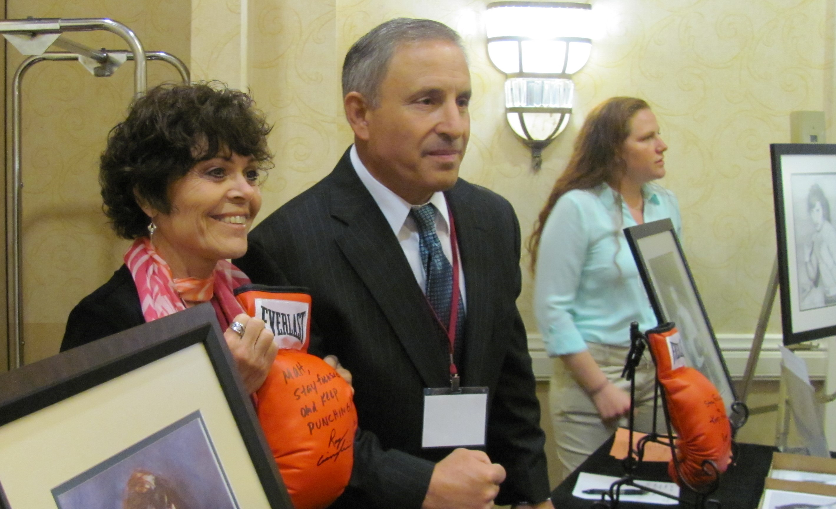 Ciancaglini presents BIANYS BOD President, Lois Tannenbaum, with a signed boxing glove.